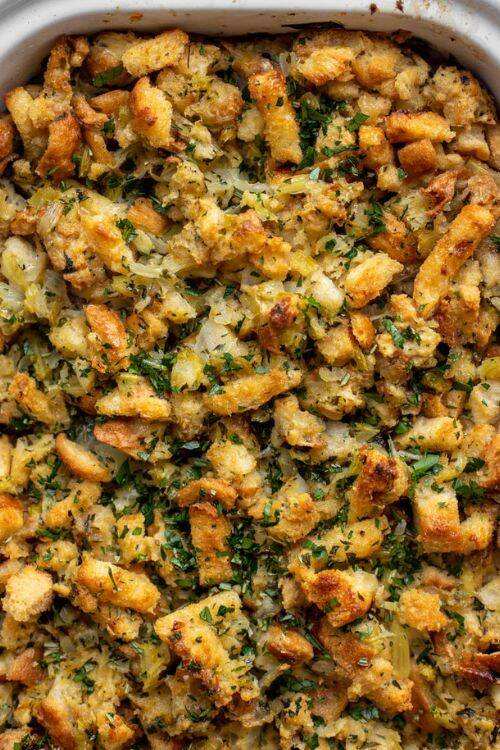Traditional bread stuffing with herbs, celery, and onions baked in a loaf pan with a golden crust
